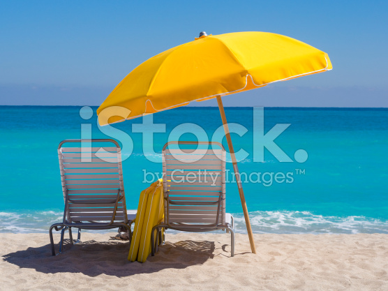 stock-photo-23407090-yellow-umbrella-and-deck-chairs-south-beach-miami